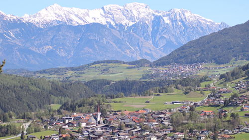 Panoramic view of townscape and mountains against sky