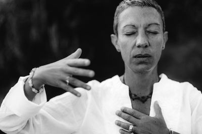 Spiritual coach sending positive thoughts hand gesture