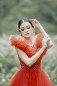 Portrait of smiling young woman red gown