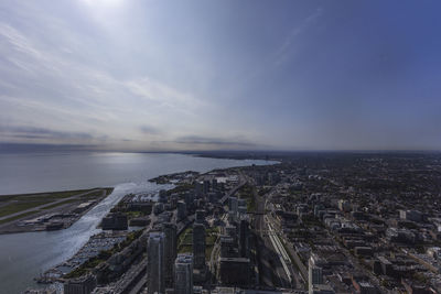 Aerial view of city against cloudy sky