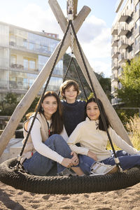 Mother with children on swing