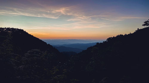 Scenic view of silhouette mountains against sky at sunset