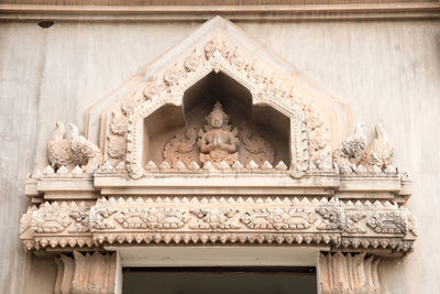 Low angle view of statue against building