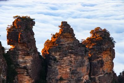 Low angle view of rock formation against sky