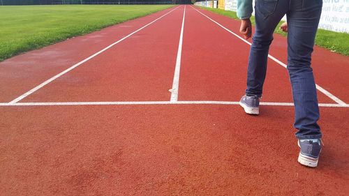 Low section of person on starting line at running track