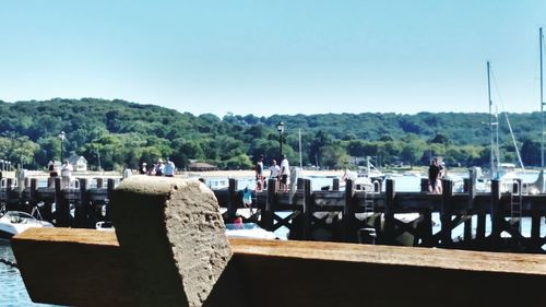 View of boats on landscape against clear sky