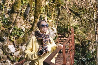 Portrait of smiling young woman in forest