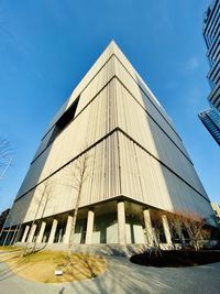 Low angle view of modern building against blue sky