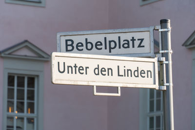 Close-up of road sign against building