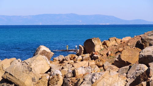 Panoramic view of rocks on beach against sky