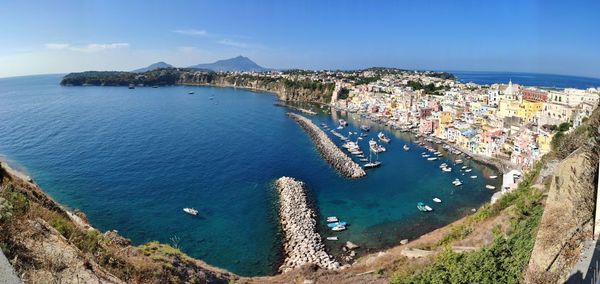 High angle view of townscape by sea against sky