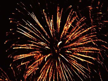 Low angle view of firework display at night