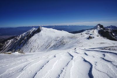 Scenic view of snowcapped mountains against sky