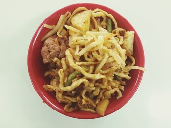 Close-up of food in plate against white background