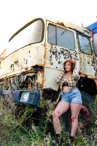 Full length of woman in old abandoned bus