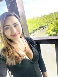 Portrait of smiling young woman seen through glass