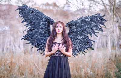 Portrait of beautiful young woman wearing angel costume