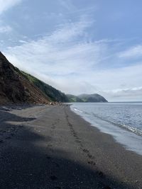 Road by sea against sky