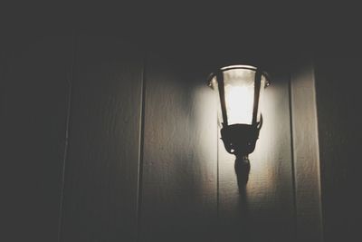 Illuminated lamp hanging on ceiling