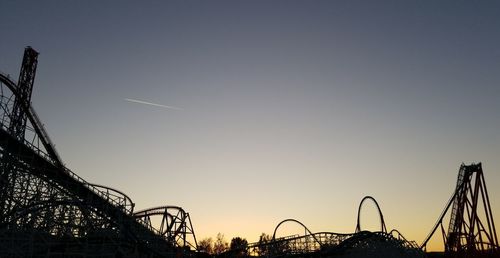 Low angle view of amusement park against clear sky