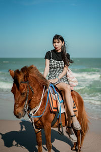 Portrait of woman standing on beach