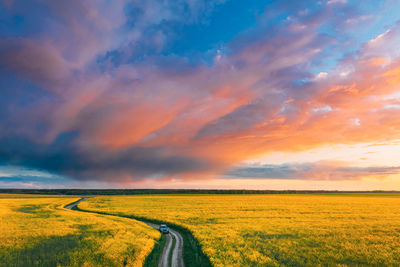 Scenic view of field against sky during sunset