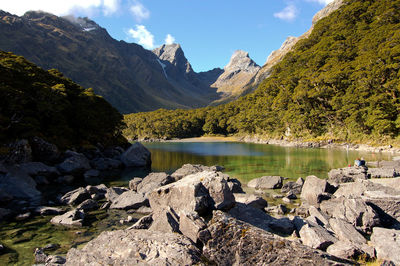 Scenic view of lake and mountains against sky