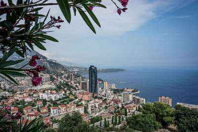 View of city by sea against sky