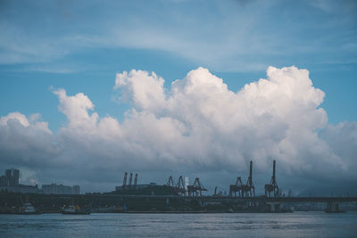 Calm sea against cloudy sky