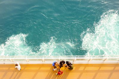 High angle view of people relaxing in swimming pool