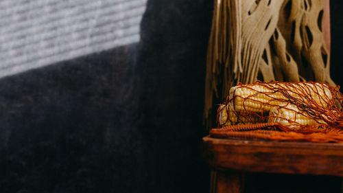 Slow food, natural vegan food concept. rustic still life with corn in mesh net bag 