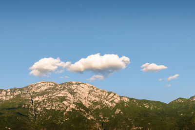 Low angle view of mountain against blue sky