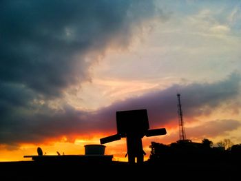 Silhouette basketball hoop against sky during sunset