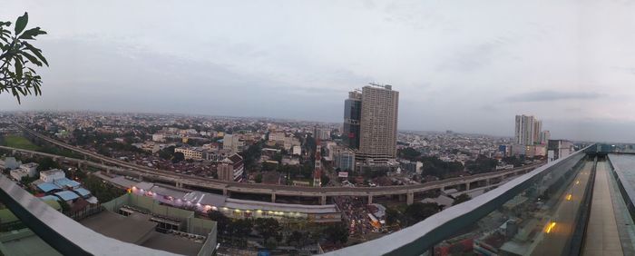 High angle view of street amidst buildings against sky