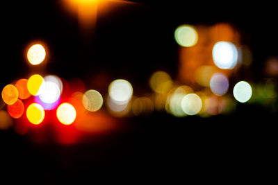 Defocused image of illuminated street lights at night