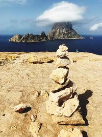 View of rocks on beach against sky