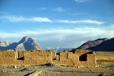 Panoramic view of castle and mountains against sky