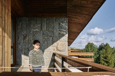 Cute girl standing in balcony