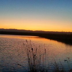 Scenic view of lake at sunset