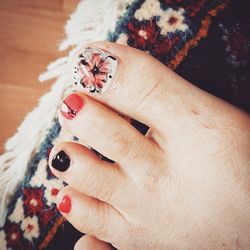 Cropped image of woman leg with nail art