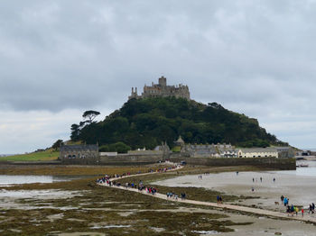 Scenic view of sea and buildings against sky