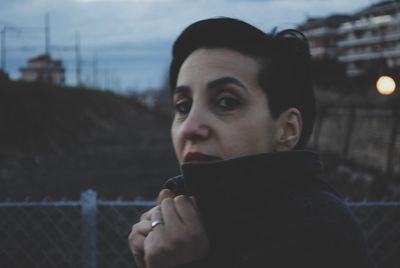 Close-up portrait of woman against clear sky