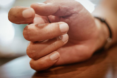 Cropped hand of man at table