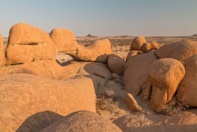 Rock formations in desert against sky
