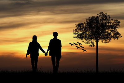 Silhouette couple walking against sky during sunset