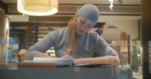 Young woman looking at illuminated table