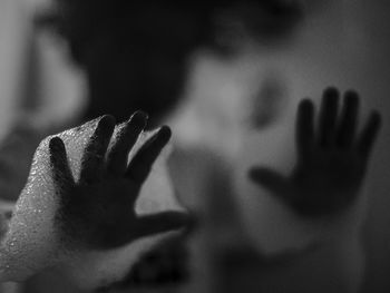 Close-up of hand touching shadow