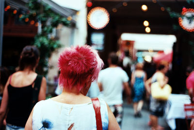 Rear view of people walking on street