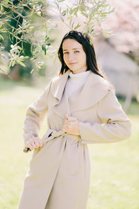 Portrait of a beautiful young woman standing outdoors