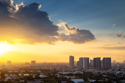 Scenic view of buildings against sky during sunset